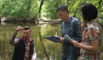 Three scientists taking a water sample