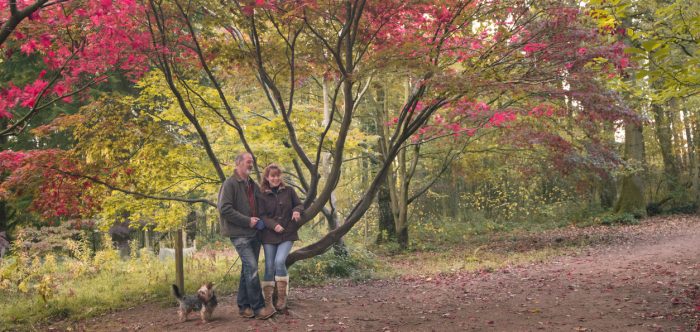 Mature adult couple in autumn woodland