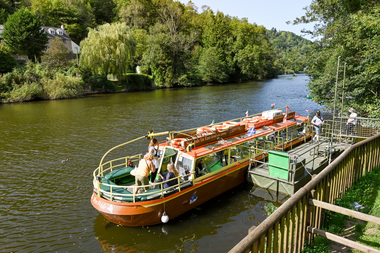 People getting off a small boat after a trip on the River Wye