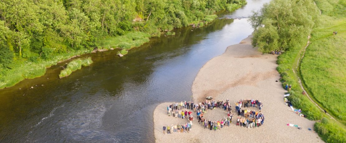 Over 130 people form a human SOS on the riverbank of the Wye