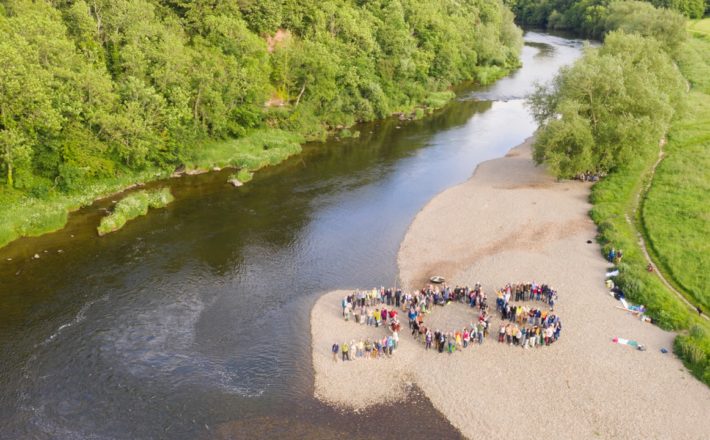 Over 130 people form a human SOS on the riverbank of the Wye