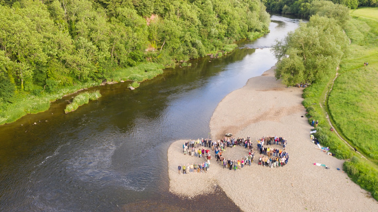 Over 130 people form a human SOS on the riverbank of the Wye