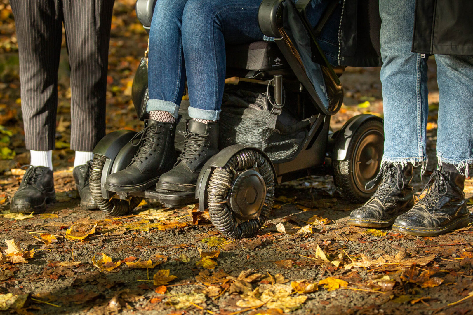 3 pairs of feet ready to set off on a path