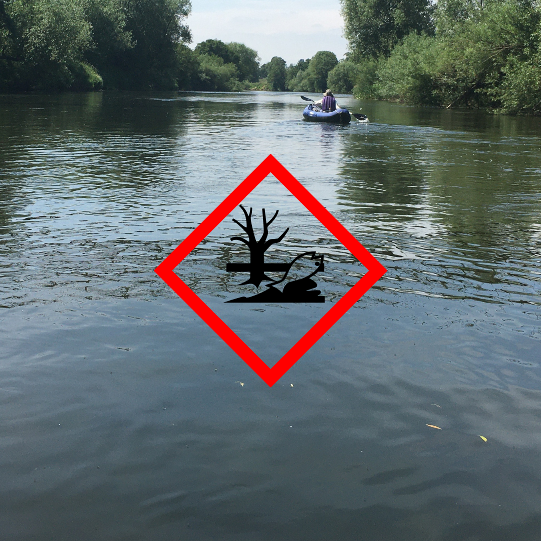 Photo of the River Wye with a pollutant sign in front